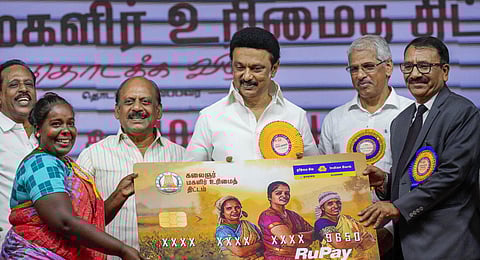 Tamil Nadu Chief Minister M.K. Stalin with a beneficiary during the launch of the 'Kalaignar Magalir Urimai Thittam. (Photo | PTI)