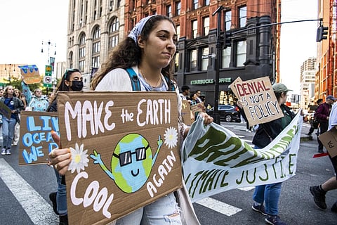 FILE - Activists walk through lower Manhattan for the Global Climate Strike protests, Sept 23, 2022, in New York. (Photo | AP)