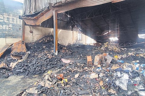 The aftermath of the fire that destroyed Rs 4 crore worth footwear at a warehouse in Kengeri Satellite Town, Bengaluru, on Friday. (Photo | Express)
