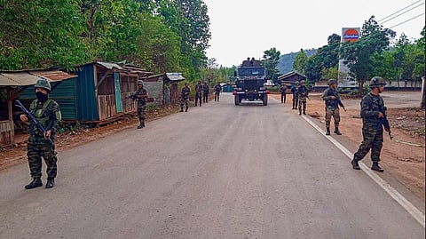 Army and Assam Rifles personnel conduct a flag march in violence-hit areas across Manipur. 