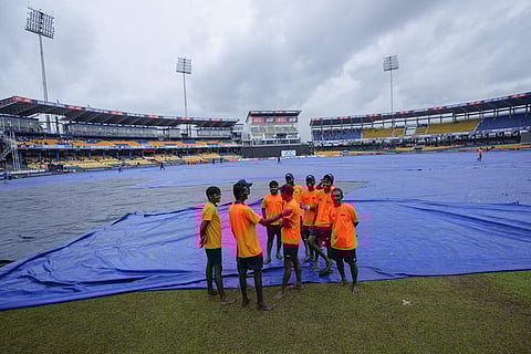 FILE - Ground personnel stand on the field as the Asia Cup cricket match between Sri Lanka and Pakistan is delayed due to a wet outfield in Colombo, Sept.14, 2023. (Photo | AP)