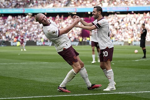 Manchester City's Erling Haaland, left, celebrates with Bernardo Silva after scoring his side's third goal during their English Premier League soccer match against West Ham United. (Photo | AP)