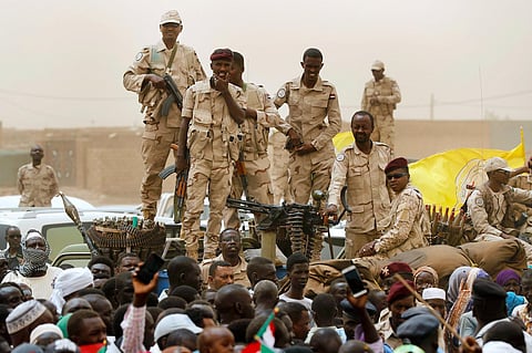 Sudanese soldiers from the Rapid Support Forces unit stand on their vehicle during a military-backed rally, in Mayo district, south of Khartoum, Sudan. 