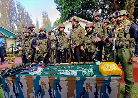 Brigadier PMS Dhillon, Commander 161 Brigade and other Army officials display arms and ammunition recovered from two killed militants, in Hatlanga area of Uri in Baramulla. (PTI)