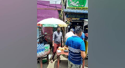 Mohammad Insaaf (left) setting up a stall outside his shop near stadium. (Photo | Express)