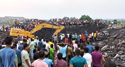 People gather as rescue operation underway after three women were sucked into a crater following land subsidence in a colliery area of Jharkhand's Dhanbad district on Sunday.(Photo | ANI)