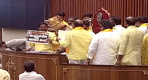 TDP MLAs walk up to the Well of the Assembly, protesting against the arrest of former CM and party president N Chandrababu Naidu.(Photo | Screengrab)