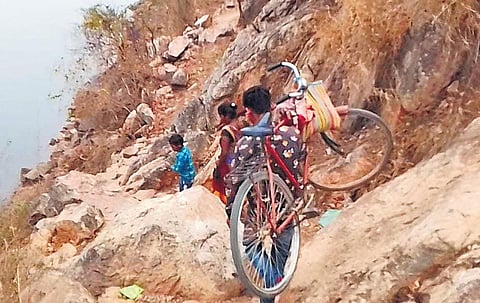Tribals of Chimtighati village in Simdega carry bicycles on their shoulders to cross the hill to reach home | Express