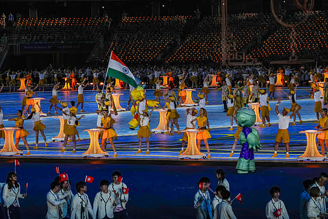 Flag-bearers Lovlina Borgohain and Harmanpreet Singh lead the Indian contingent during the opening ceremony of the 19th Asian Games. (Photo | PTI)