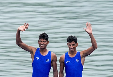 Arjun Lal Jat and Arvind Singh wave Indian tricolours as they stand at the podium after winning silver medal in Men's Light-weight Double Sculls at the 19th Asian Games. (PTI)