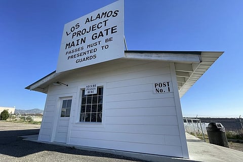 A sign marks a roadside rest stop that has been made to look like the historic security gate that all Manhattan Project workers passed through in Los Alamos, N.M., on June 26, 2023. (AP)