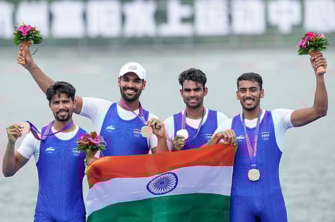 (L to R)- India's Sukhmeet Singh, Parminder Singh, Jakar Khan and Satnam Singh with their bronze medals at the Men's Quadruple Sculls event of rowing at the 19th Asian Games. (PTI)
