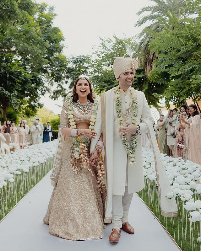 The newly married couple walking down the aisle hand-in-hand.  (Parineeti Chopra Instagram)