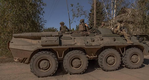 Ukrainian servicemen ride on top of an armoured personnel carrier in Kostyantynivka, Donetsk region. (Photo| AFP)
