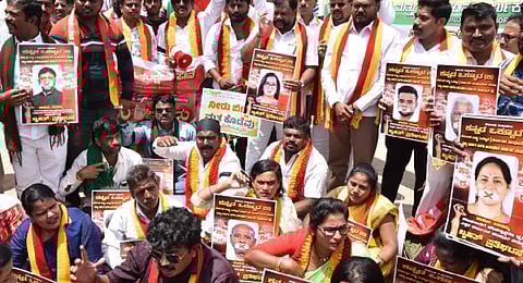 Kannada activists holds posters of the CM, DyCM and Karnataka MPs and protest the release of Cauvery water, at Freedom Park in Bengaluru on Tuesday | Shashidhar Byrappa