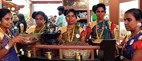 Tribal women farmers with the Keezhanthoor coffee at the World Coffee Conference in Bengaluru. (Photo | Express)