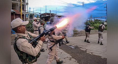 FILE - A policeman fires tear gas at the protesters in Imphal, as they demand restoration of peace in the state after ethnic violence, Sept 21, 2023. (Photo | AFP)