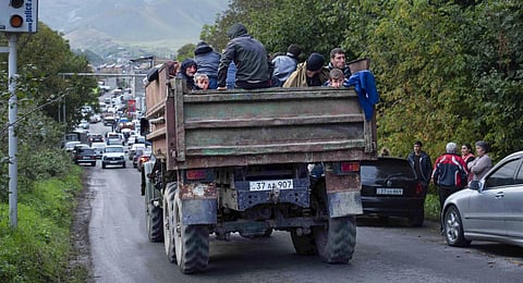 Ethnic Armenians from Nagorno-Karabakh sit in a truck on their way to Goris in Syunik region, Armenia. (Photo | AP)