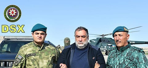 Azerbaijan's border guard officers pose with the detained Ruben Vardanyan, former head of Nagorno Karabakh govt, center, in Nagorno-Karabakh. (Photo | AP)