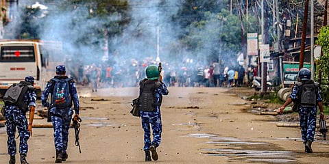 Security personnel fire tear gas shells as students protest against the killing of two Meitei students. (Photo | PTI)