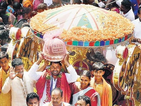 Builder Dayanand Reddy and his family members carry the 21 kg laddu to the Hanuman Temple in Balapur on Thursday