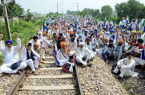 A group of farmers raise slogans as they block railway tracks during a protest demanding flood compensation, MSP guarantee law and debt relief, in Amritsar,  Sept. 28, 2023. (Photo | PTI)