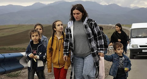 Ethnic Armenians fleeing Nagorno-Karabakh walk on a road to Kornidzor, in Armenia's Syunik region. (Photo | AP)