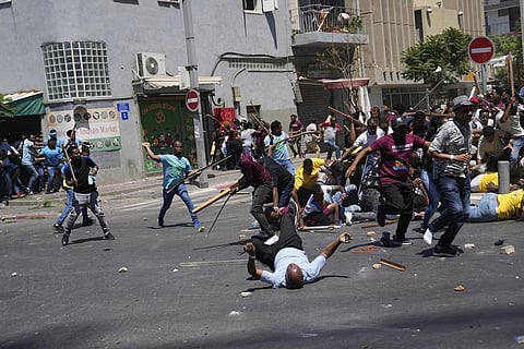 Anti-Eritrean government activists, left, clash with supporters of the Eritrean government, in Tel Aviv, Israel, Saturday, Sept. 2, 2023.