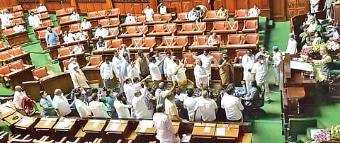 Congress legislators protest in the well of the House during a discussion on ‘One Nation, One Election’ idea in the  Legislative Assembly, in Bengaluru.