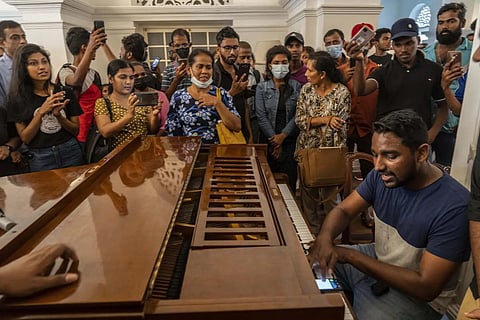 A man plays the piano at the Prime Minister's official residence after it was stormed in Colombo, Sri Lanka, on July 11, 2022. (File | AP)