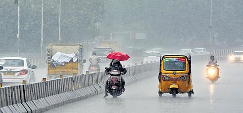 Motorists make their way through the rain at Saidapet on Sunday | Ashwin Prasath