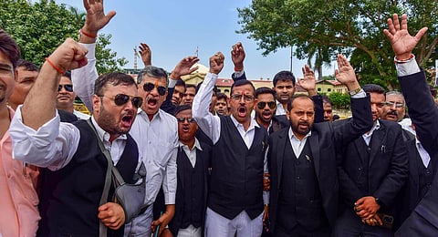 Lawyers of Allahabad High Court raise slogans during a protest over the alleged police lathi-charge on advocates in Hapur district.(Photo | PTI)