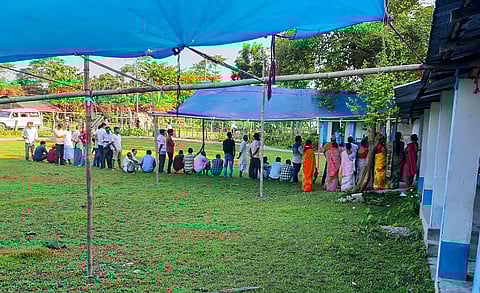 Voters wait in a queue to cast their votes during the by-elections to Dhupguri assembly seat, in West Bengal's Jalpaiguri district, Tuesday, Sept. 5, 2023. (Photo | PTI)