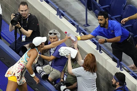 Madison Keys, of the United States, hands water and towels to a security guard for a patron that was having a medical issue during the US Open tennis championships, Sept 6, 2023. (Photo | AP)
