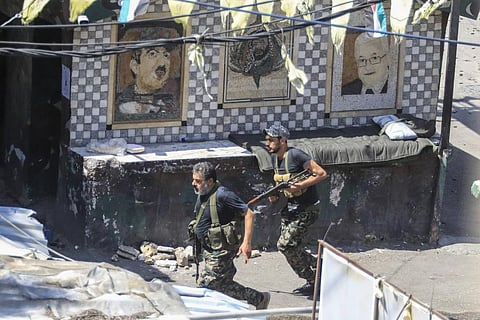 Members of the Palestinian Fatah group run to take position during a third day of clashes that erupted with Islamist factions in the Palestinian refugee camp of Ein el-Hilweh. (Photo | AP)