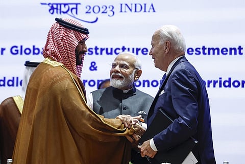 Saudi Arabian Crown Prince Mohammed bin Salman Al Saud, left, and U.S. President Joe Biden, right, shake hands next to Indian Prime Minister Narendra Modi at the G20 summit (Photo | AP)