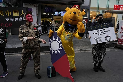 Protesters dress up to depict authoritarian China and Winnie the Pooh representing Chinese President Xi Jinping, dressed as an emperor, and holding a Taiwan island.(Photo | AP)