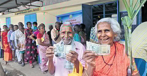 People are seen waiting in a queue to collect Pongal gift  with Rs 1000 from a ration shop at Madurai. (Photo | K.K.Sundar)