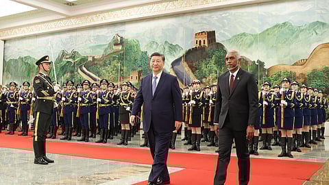 Maldives' President Mohamed Muizzu (R) and Chinese President Xi Jinping walking during a welcome ceremony at the Great Hall of the People in Beijing, January 10, 2024. 