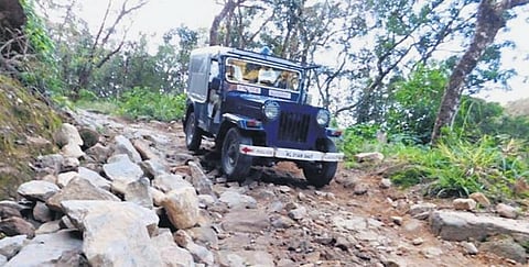 A police jeep takes on rough terrain on its way to Edamalakkudy