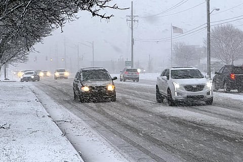 Early rush hour traffic is seen along Orchard Lake Road in West Bloomfield, Michigan, shortly after the start of a winter storm Friday. (Photo | AP)