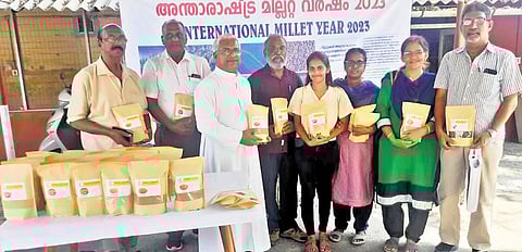 Fr Jacob Pallackapilly, director, Pastoral Orientation Centre, with participants at the subsidised millet sales programme on Saturday. (Photo | Express)