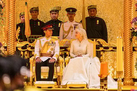 Prince Abdul Mateen and Yang Mulia Anisha Rosnah sit during their wedding reception at Istana Nurul Iman in Brunei's capital Bandar Seri Begawan on January 14, 2024. | AFP