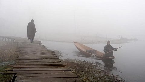 The residents of the lake, who live in houseboats, had a tough time breaking the ice layer while roving their boats towards the banks. (Photo | PTI)