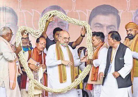 Home Minister Amit Shah, along with Bihar BJP chief Samrat Choudhary and state LoP Vijay Kumar Sinha, at a rally in Lakhisarai, Bihar. (Photo | PTI)