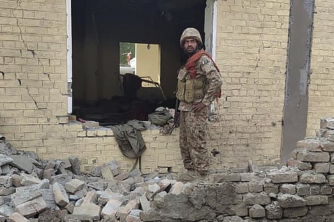 An army soldier examines damages on the site of a bombing at a police station on the outskirts of Dera Ismail Khan, Pakistan. (Photo | AP)