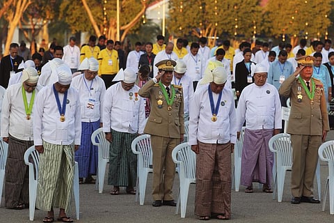 Myanmar government officials salute at their national flag during a ceremony marking Myanmar's 76th anniversary of Independence Day. (Photo | AP)