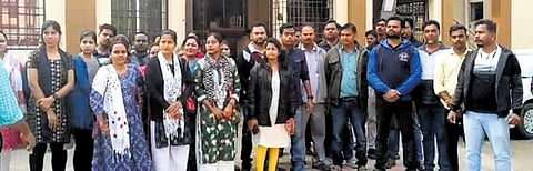 The agitating staff of Odisha State Open University. (Photo | Express)