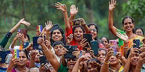 Supporters of Prime Minister Narendra Modi gather to welcome him as he arrives for the 'Sthree Shakthi Modikkoppam' Mahila Sangamam, in Thrissur. (Photo | PTI)