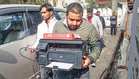 ED officials carry a printer to architect Vinod Singh’s premises in Ranchi | PTI
